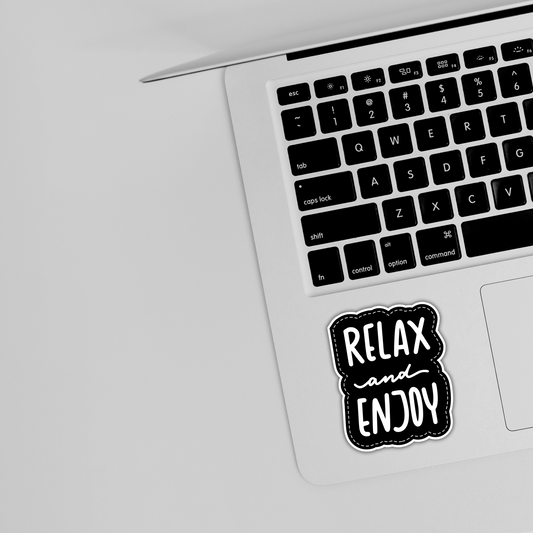Black and white Relax and Enjoy sticker on silver laptop keyboard, cute trendy sticker design