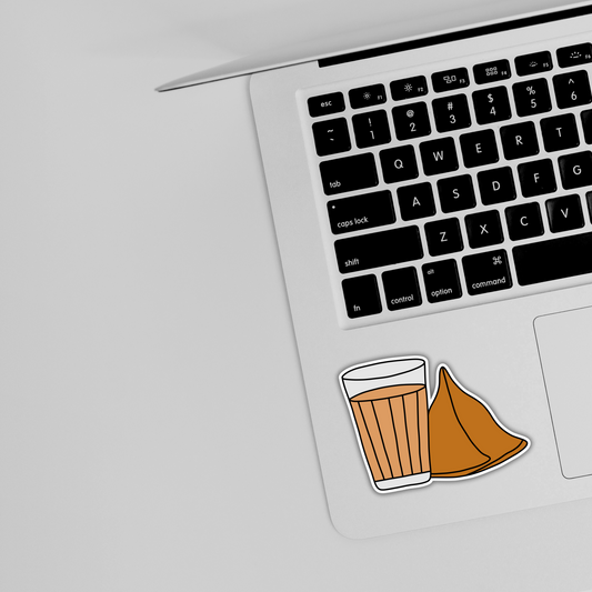 Cute tea and samosa sticker on silver laptop keyboard, trendy sticker design from Sticksnap
