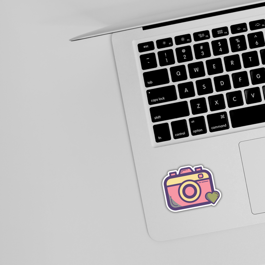 Pink camera sticker with heart on silver laptop, cute trendy design from Sticksnap